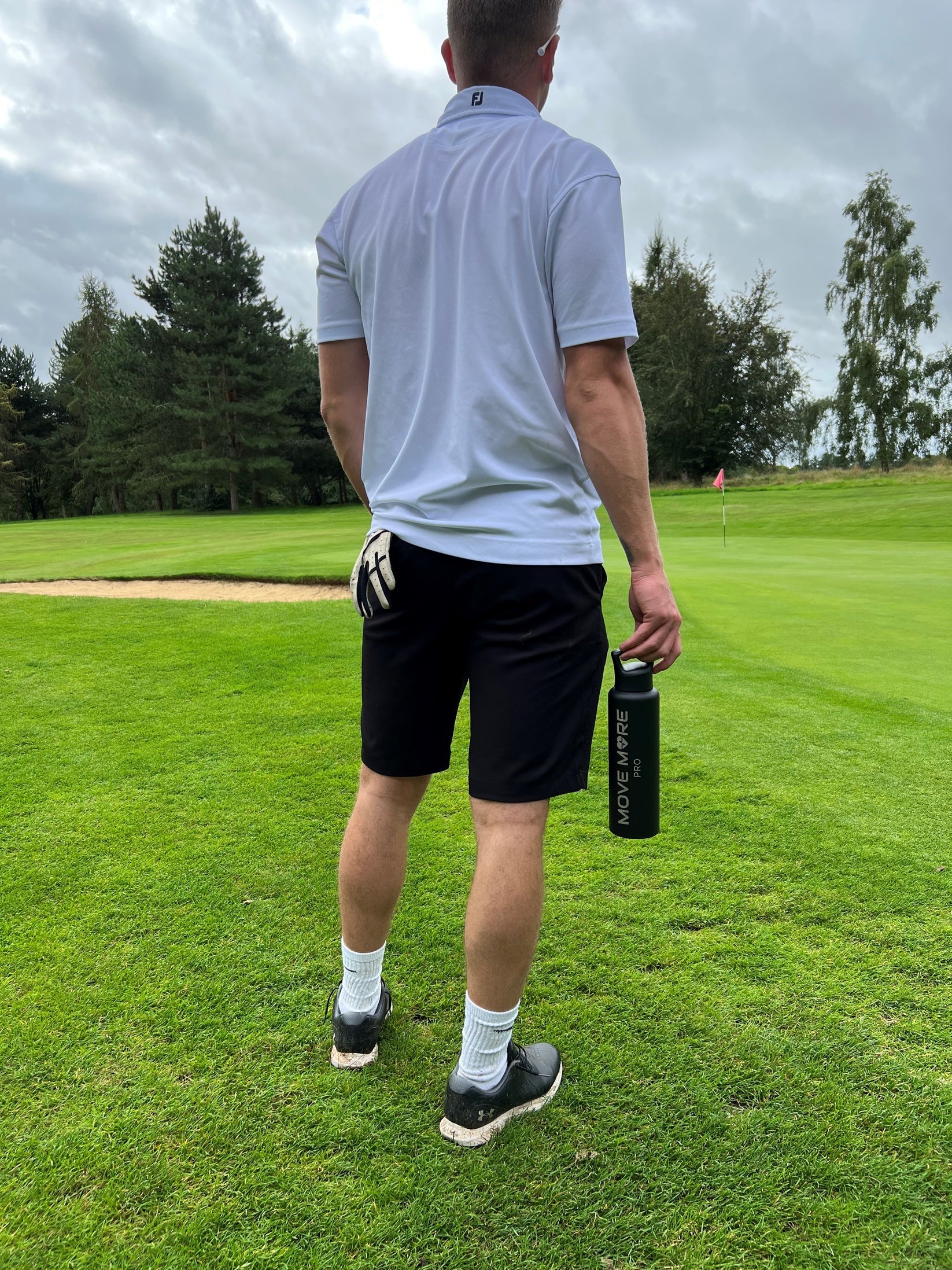Black bottle on the golf course